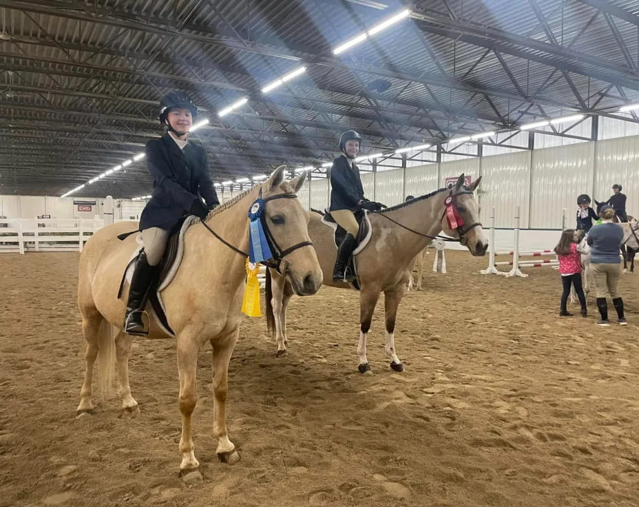 a couple of people riding horses
