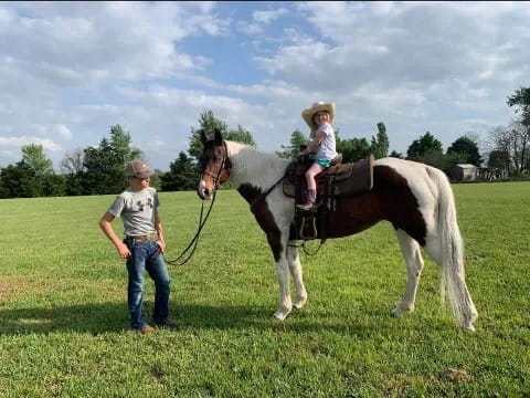 a person and a girl on a horse