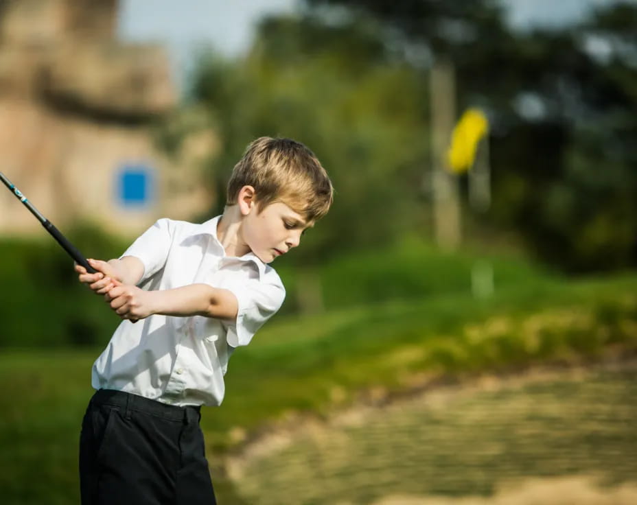 a boy swinging a bat