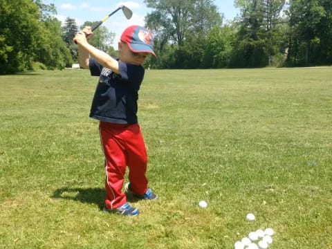 a kid swinging a baseball bat