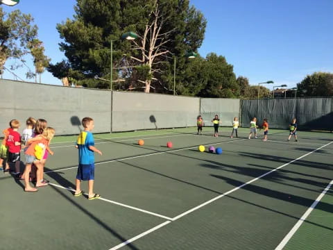 kids playing tennis on a court