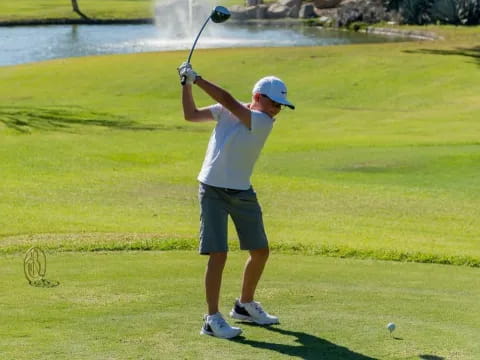 a person swinging a golf club