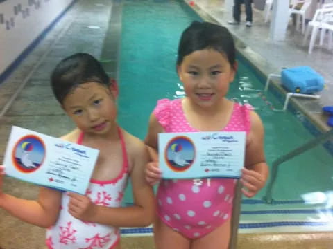 two girls holding signs