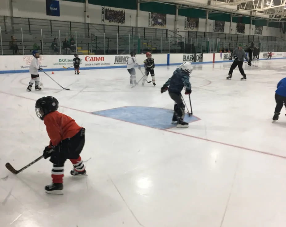 a group of people playing hockey