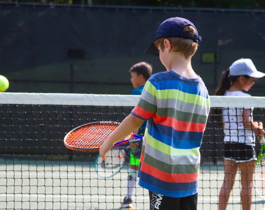 a boy playing tennis