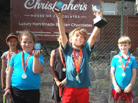 a group of boys holding trophies