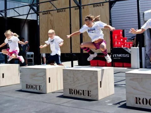 a girl jumping over a podium