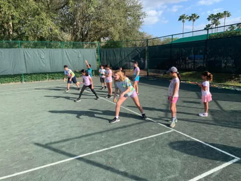 a group of girls playing tennis