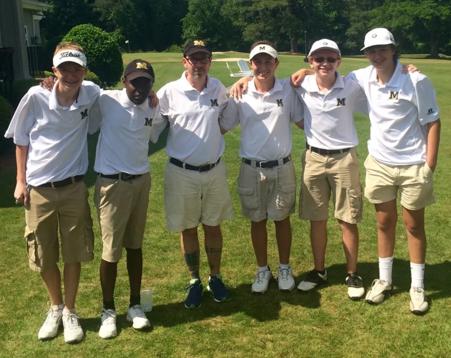 a group of men wearing white shirts