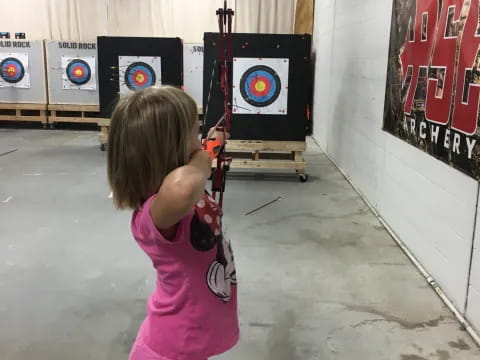 a girl holding a bow and arrow