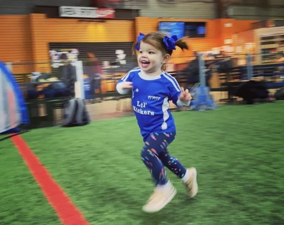 a girl running on a field