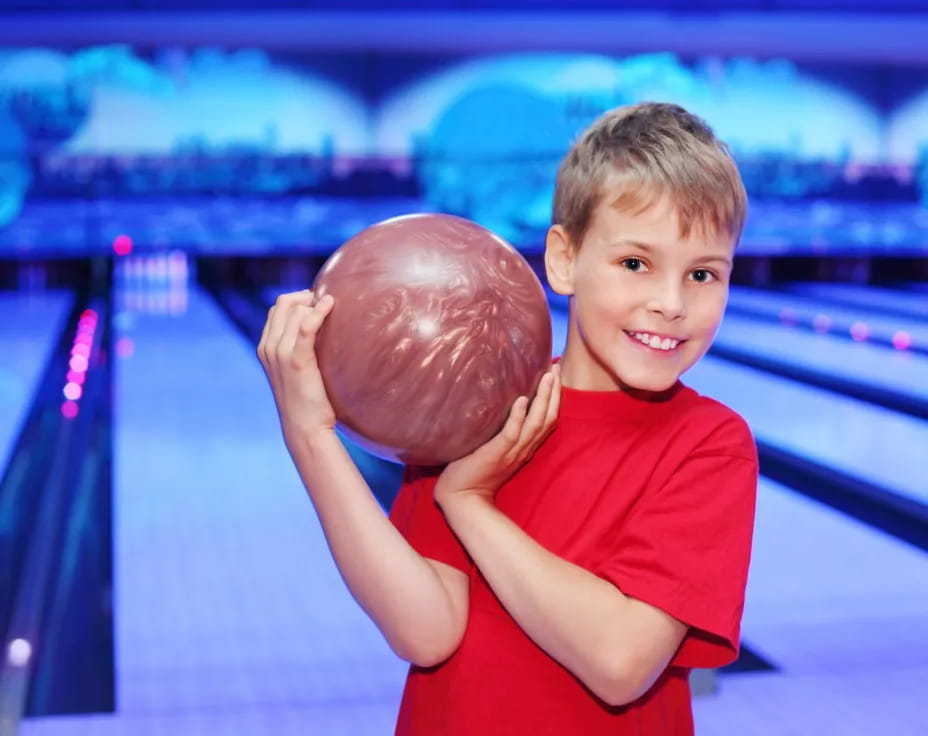 a boy holding a ball