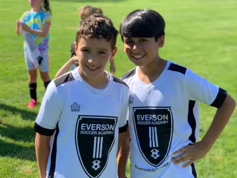two boys in sports uniforms