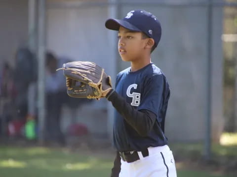 a young boy in a baseball uniform