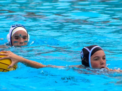 two women swimming in a pool
