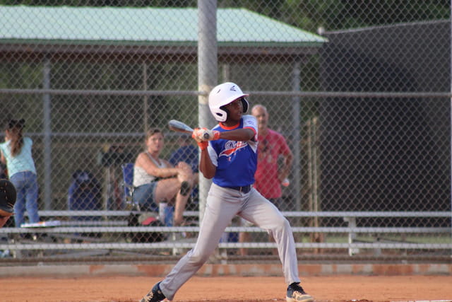a kid swinging a baseball bat