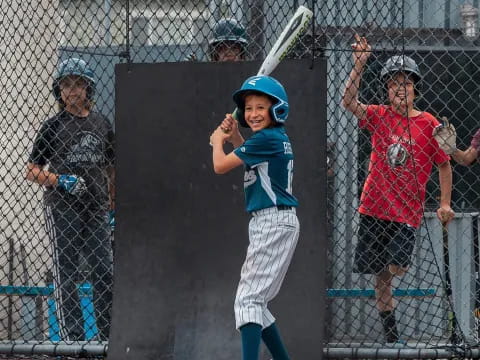 a kid holding a baseball bat