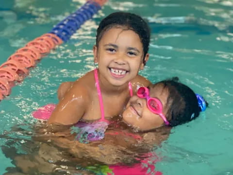 a girl and a baby in a pool