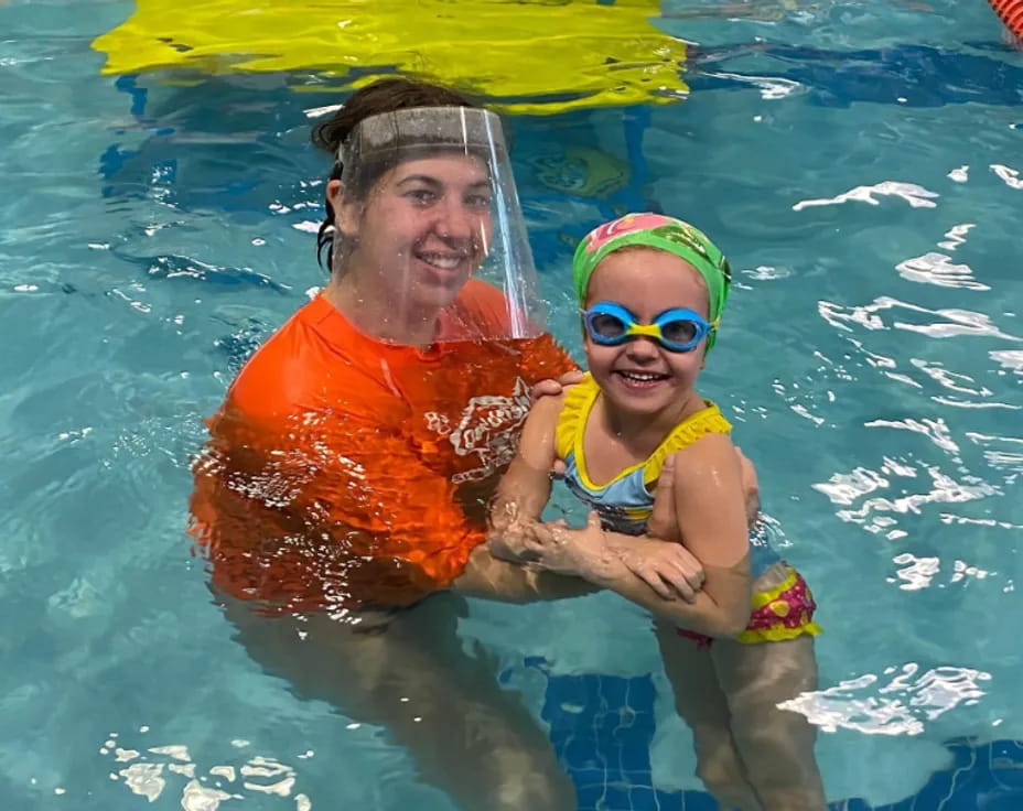 a man and a child in a pool