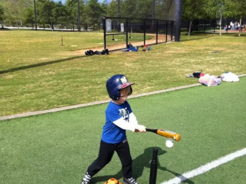 a kid swinging a baseball bat