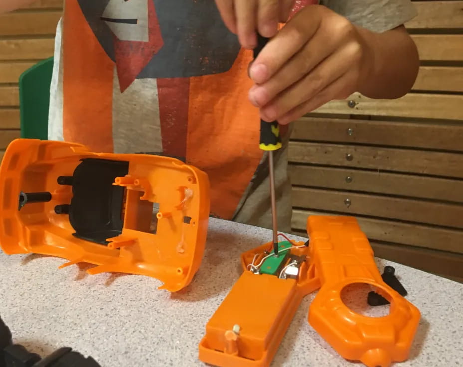 a person cutting a toy
