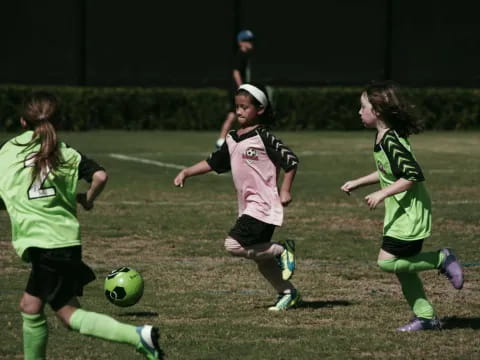 girls playing football on a field
