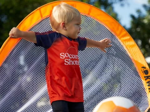 a boy playing with a ball