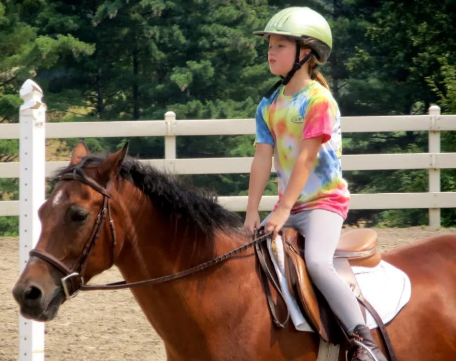 a girl riding a horse