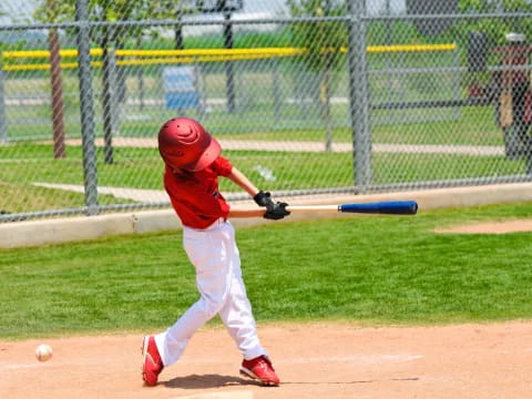 a kid swinging a baseball bat