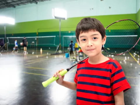 a boy holding a tennis racket
