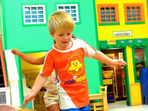 a boy in a yellow shirt