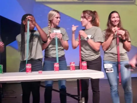 a group of women singing on stage