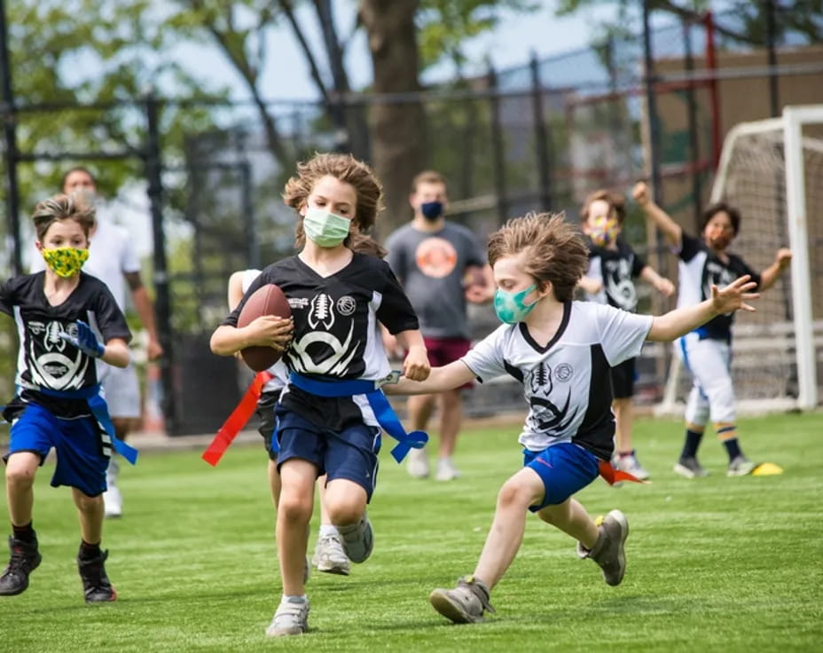 a group of kids playing football