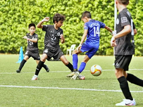 a group of kids playing football