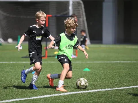 kids chasing a football ball