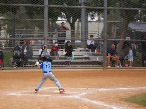 a kid swinging a baseball bat
