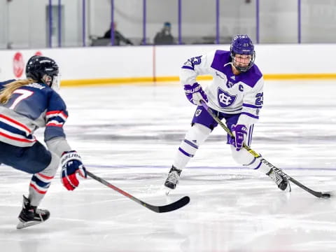 a couple of people playing hockey