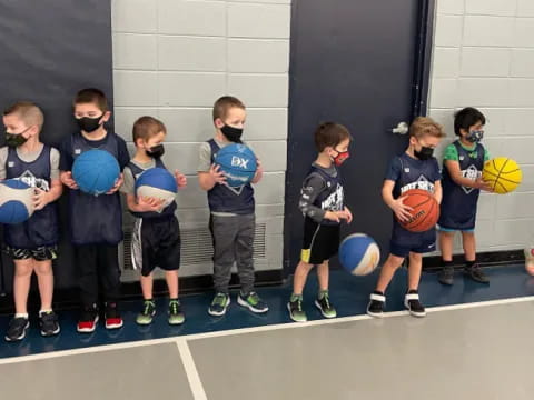a group of kids holding balls