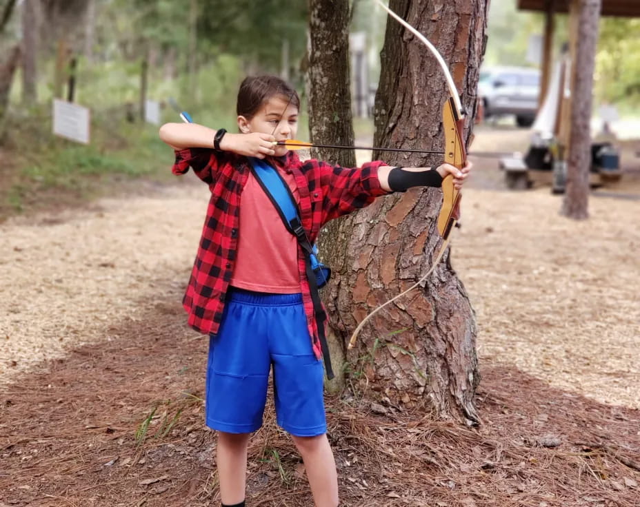 a boy holding a bow and arrow