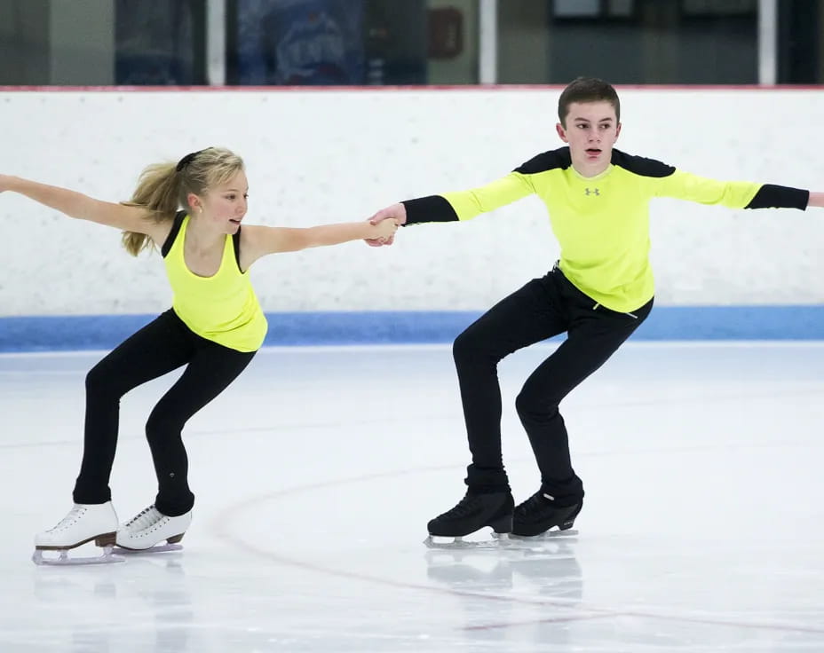 a man and a woman ice skating