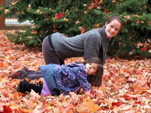 a man and woman lying in leaves