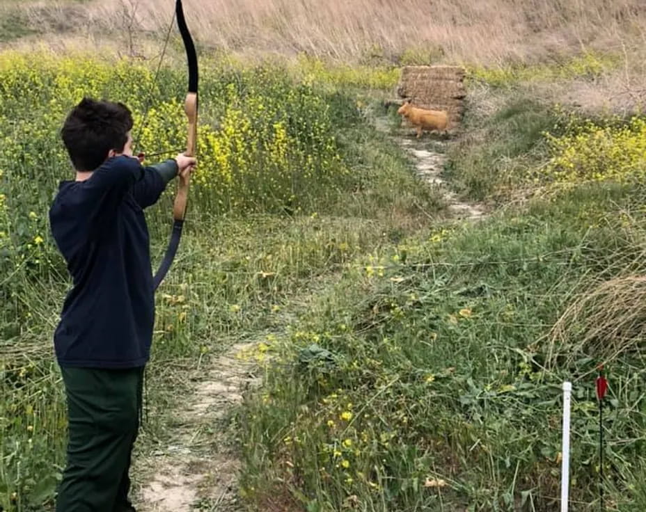 a boy holding a bow and arrow