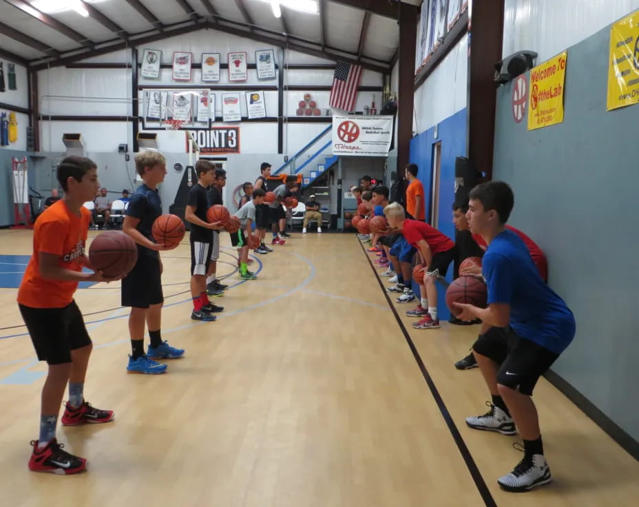 a group of kids playing basketball