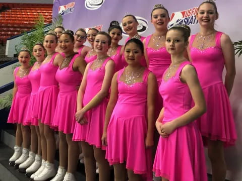 a group of women in pink dresses