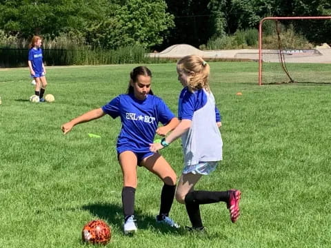 girls playing football on a field