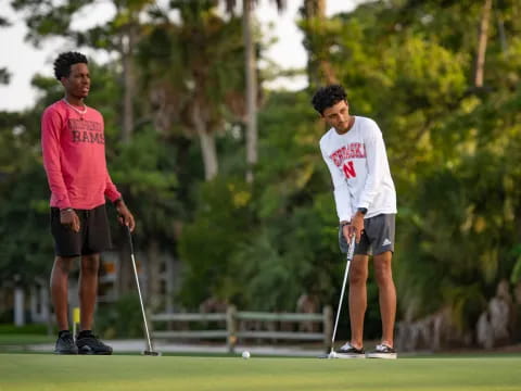 a couple of men playing golf