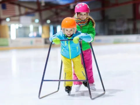 a couple of kids on ice skates