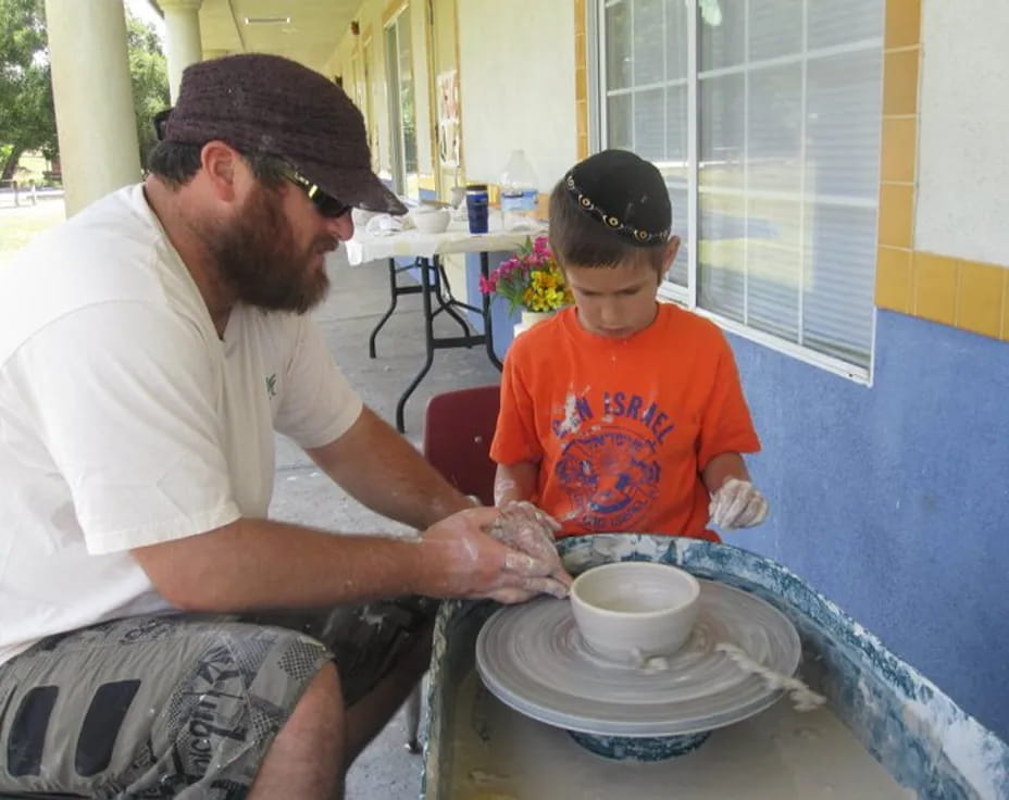 a man and a boy sitting outside