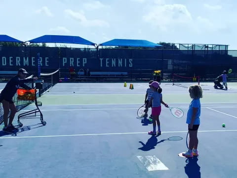 a group of people play tennis