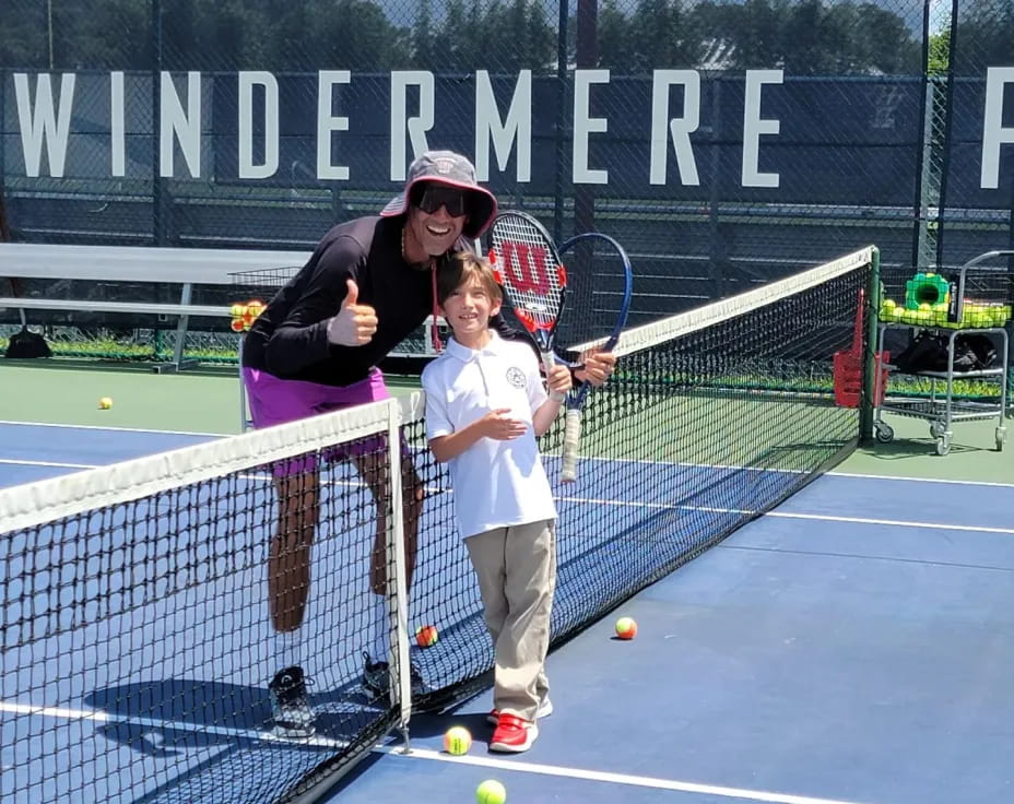 a man and a boy playing tennis